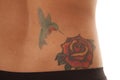 Tattoo close rose on lower back