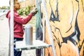 Tattoo Graffiti Writer Painting With Color Spray On The Wall - Contemporary Artist At Work - Urban Lifestyle,street Art Concept -