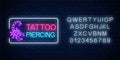 Tattoo and piercing parlor glowing neon signboard with scorpio emblem and alphabet. Tattooing salon sign Royalty Free Stock Photo