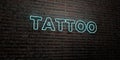TATTOO -Realistic Neon Sign on Brick Wall background - 3D rendered royalty free stock image Royalty Free Stock Photo