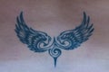 The tattoo in the shape of wings on the back