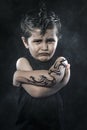 Tattooed boy, rebellious child, funny guy with slicked back hair Royalty Free Stock Photo