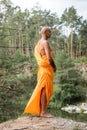 tattooed buddhist in traditional orange robe