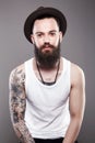 Handsome Bearded Man in Hat, with tattoo Royalty Free Stock Photo