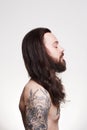 Tattooed handsome bearded man with long hair