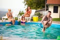 Tattooed man jump bomb style in pool Royalty Free Stock Photo