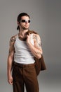 Tattooed man in sunglasses holding jacket Royalty Free Stock Photo