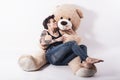 Tattooed natual looking woman playing with giant teddy bear