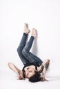 Tattooed natual looking woman with short black hair lying down on bright background Royalty Free Stock Photo