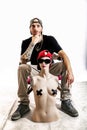 Tattooed rap singer posing in studio with a female dummy Royalty Free Stock Photo