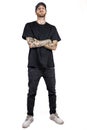 Tattooed rap singer posing in studio wearing black clothes Royalty Free Stock Photo