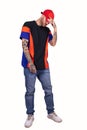 Tattooed rap singer posing in studio wearing red cap Royalty Free Stock Photo
