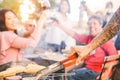 Tattooed senior man grilling hamburgers for his family at barbecue dinner party - Close up male hand cooking on bbq in the garden Royalty Free Stock Photo