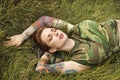 Tattooed woman in camouflage. Royalty Free Stock Photo