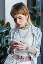 tattooed woman in silver necklaces and