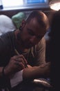 Tattooer makes scetch Royalty Free Stock Photo