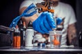 Hand of a tattooer, holding a tattoo device.