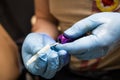 Tattooer showing process of making a tattoo, hands holding a tatoo machine Royalty Free Stock Photo