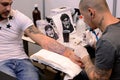 Tattooist makes a tattoo on his client's on 18 April, 2015, Sofia, Bulgaria