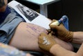 Tattooist makes a tattoo on his client's on 18 April, 2015, Sofia, Bulgaria