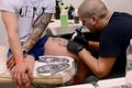 Tattooist makes a tattoo on his client's on 18 April, 2015, Sofia, Bulgaria