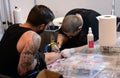 Tattooist makes a tattoo on his client's on 18 April, 2015, Sofia, Bulgaria Royalty Free Stock Photo