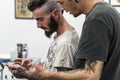 Tattooist placing the drawing on the head.
