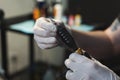 Tattooist preparing tools for procedure of drawing