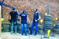 Federal Deputy Eduardo Bolsonaro listens to instructors checking targets at the Taubatexas Gun Club stand