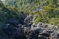 tourists gather on Aratiatia lookout to watch the river swell over rapids when dam gate