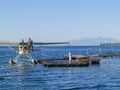 Tourist float plane at pier refueling on on popular traveler attraction with mountains in distance across lake