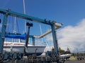 Tauranga Marina hardstand travel lift with yacht hoisted for mai