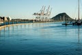 Marina floating pier with  Mount Maunganui and Port of Tauranga container berth and cranes in background Royalty Free Stock Photo