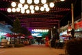 Nighttime in brightly illuminated street in city