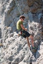 Young adventurous person rock climbing