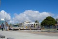 People walk along harbor edge Tauranga city waterfront playground and The Strand background.