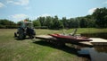 TAURIAC, FRANCE - JUNE 26: Tractor putting pedal boat on lake on June 26, 2013 on Tauriac lake, France. Tauriac leaisure park is