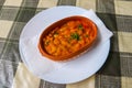 Tavche gravche (baked beans) - traditional Macedonian dish on table Royalty Free Stock Photo