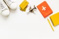 Tavelling background - airplane, shoes, notebook, passport - on white table from above copy space Royalty Free Stock Photo