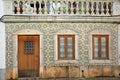 Close-up on a typical house facade with patterned tiles azulejos inside the old town of Tavira