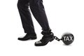 Tax ball and chain restraining businessman as he tries to walk concept for business financial burden, taxes and bankruptcy Royalty Free Stock Photo