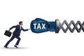 Tax concept with businessman being hit by boxing glove Royalty Free Stock Photo