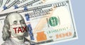 Tax concept. Tax markon hundred dollar bills background Royalty Free Stock Photo