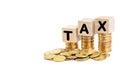 TAX Concept with wooden block and stacked coins Royalty Free Stock Photo