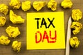 Tax Day. Business concept for Income taxation Refund written on sticky note paper on the vintage background. Folded yellow papers