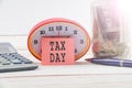 TAX DAY CONCEPT; Clock,red note,calculator and coins in the mason jar over wooden background. Royalty Free Stock Photo