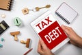 TAX DEBT. Financial difficulties, budget, real estate and the crisis concept. Tablet, house keys, stamps and money