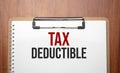 TAX DEDUCTIBLE text on white paper on the wood table