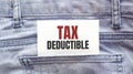 TAX DEDUCTIBLE words on a white paper stuck out from jeans pocket. Business concept