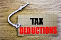 Tax Deductions. Business concept for online saleFinance Incoming Tax Money Deduction written on price tag paper with copy space on